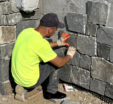 man installing stone masonry